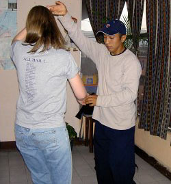 One of our teachers dancing with a student, demonstrating salsa steps during a lesson.