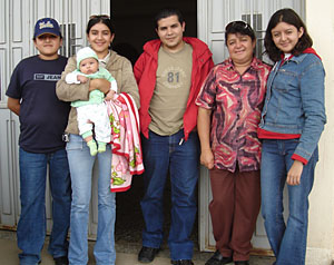 One of our homestay families in front of the entrance to their home.